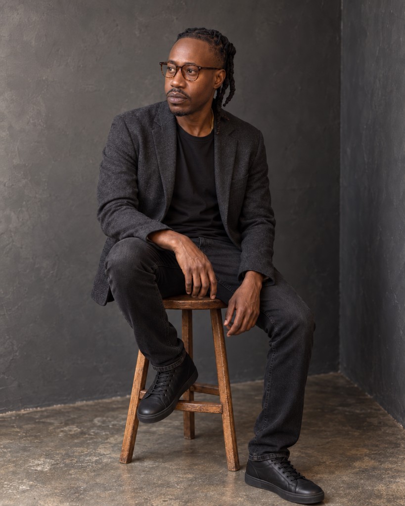 Kenneth C. Moncur, founder of LawBey, seated in a studio portrait.